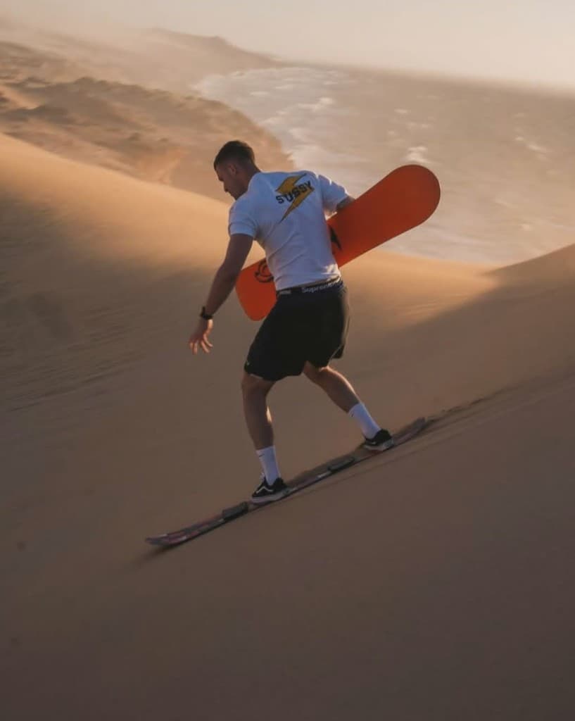 Sandboarding on Timlalin dunes Morocco